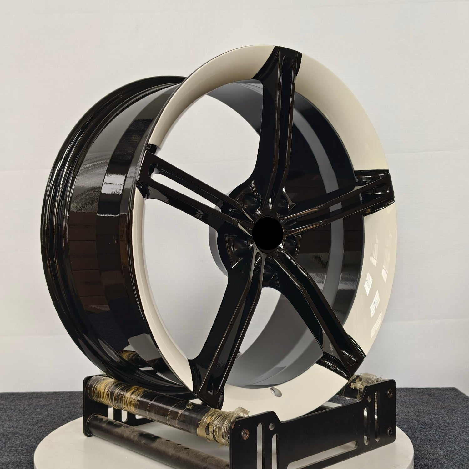Black and white wheel on a gray surface with a white background