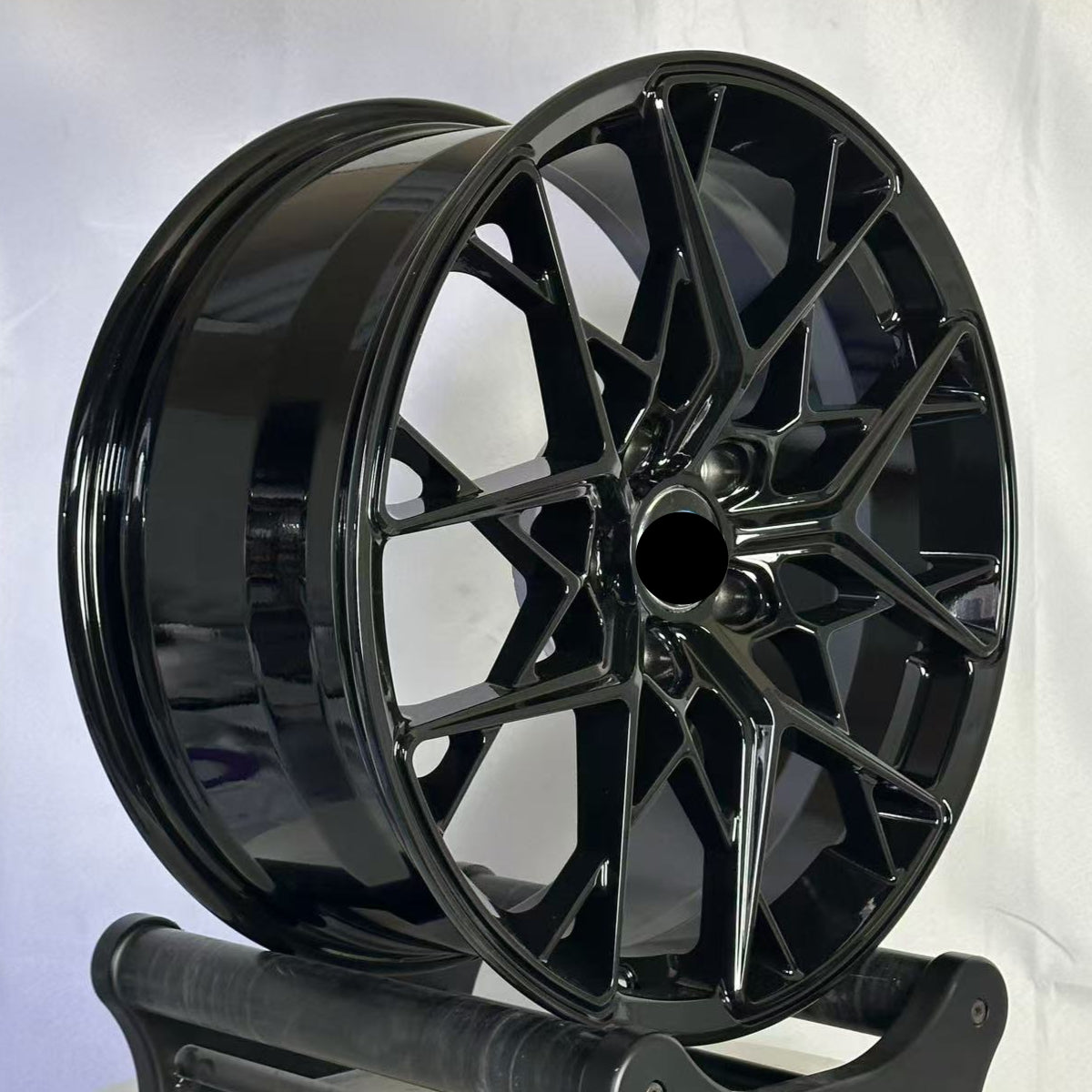 Black wheel on a stand against a white background