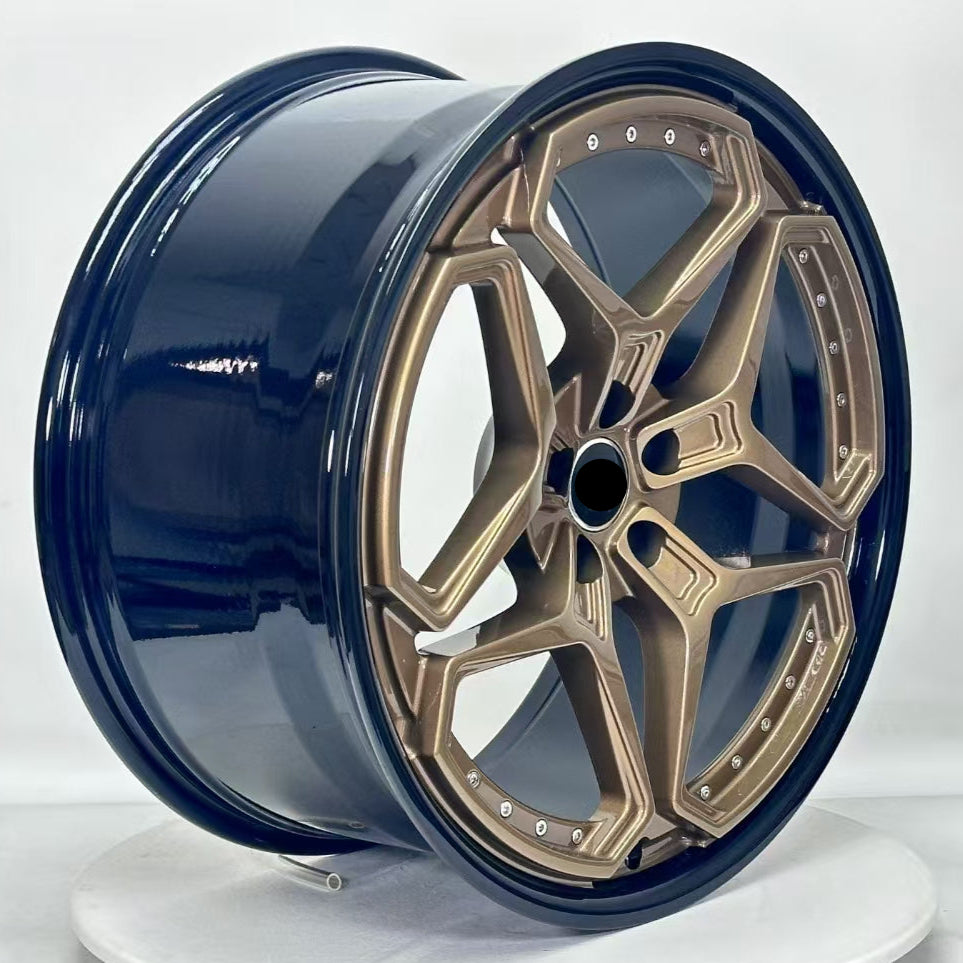 Blue and gold alloy wheel on a white background
