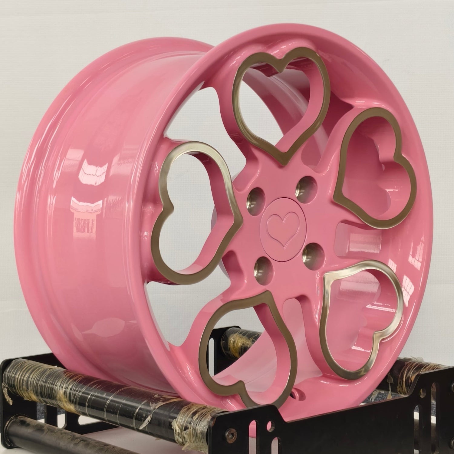Pink wheel with heart designs on a white background